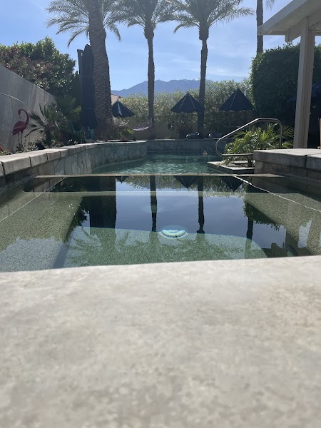 Pool maintenance service being performed on residential pool